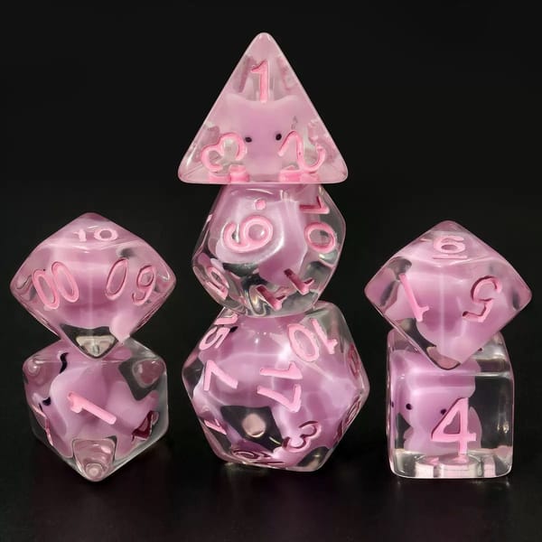 In-stock clear sharp-edge resin dice with a pink rabbit liquid core and pink numbers